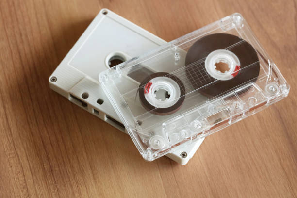 istock Cassette tape on wooden  background 674836382