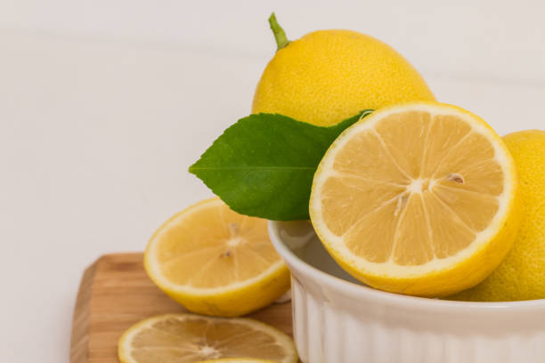 istock Fresh lemons on wooden block. 674845680