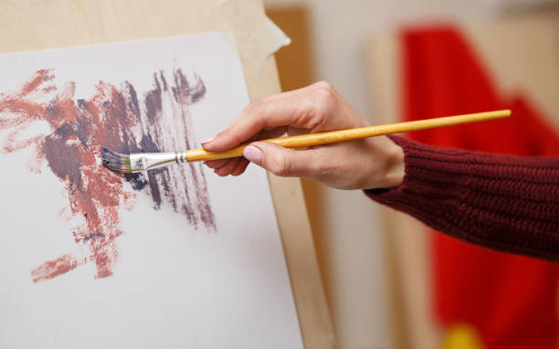 istock Girl paints with oil paints 674848252