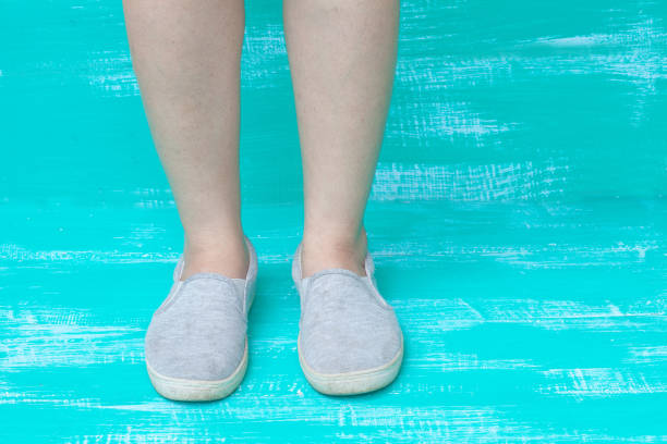 istock lady feet on color wood 674851112