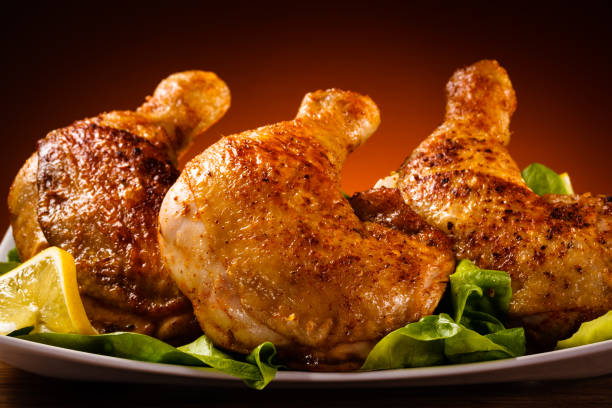 istock Grilled chicken legs with chips and vegetables 674851302