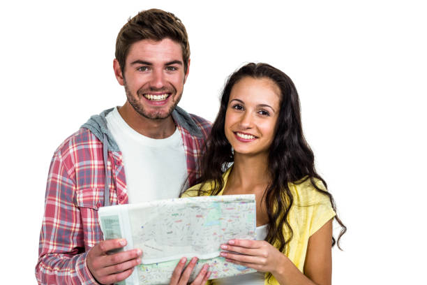 istock Portrait of smiling couple holding map 674857542