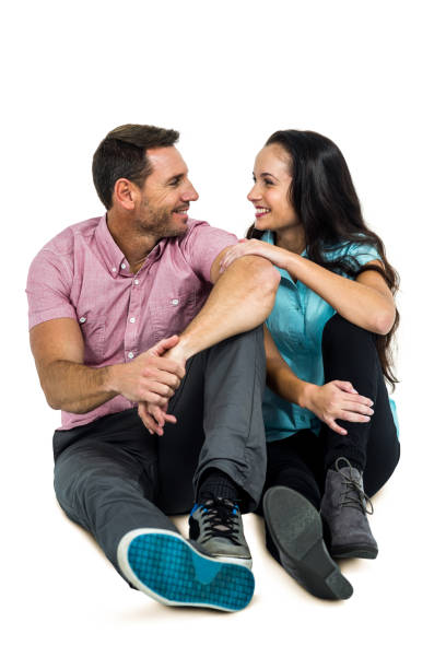 istock Happy couple sitting while looking at each other 674857784