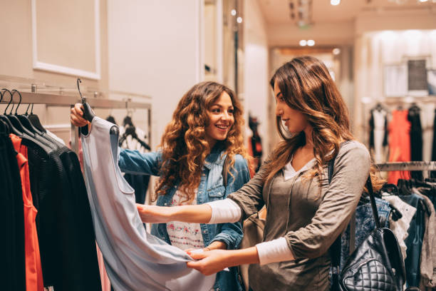 istock Two friends shopping for clothes 674860864