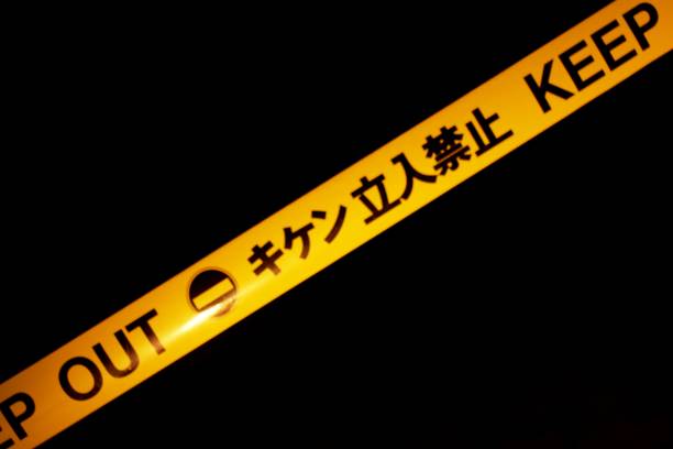 Yellow and Black WARNING Barrier Tape Background in Japan