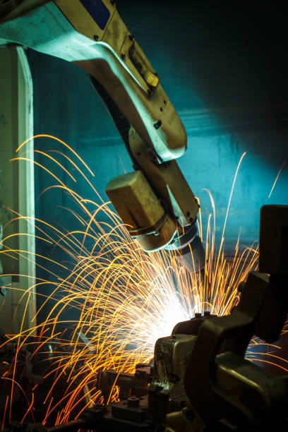 istock Welding robots movement in a car factory 674874956
