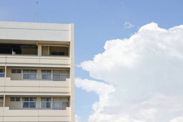istock building apartment Thailand, on blue sky the background with copy space 674875000