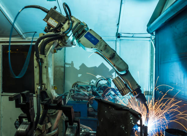 istock Welding robots movement in a car factory 674880994