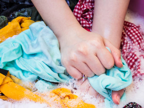 istock Women washing clothes in the enameled bowl 674885270