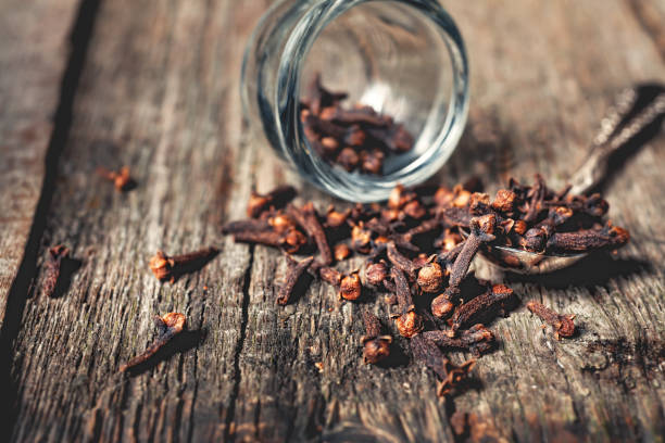 istock Cloves, old wooden background 674888272