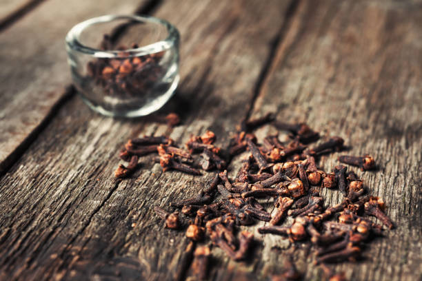 istock Cloves, old wooden background 674889296