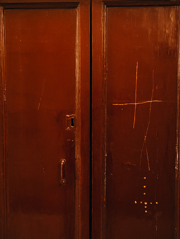 Old yellow, brown, red doors. Wood texture. Old shabby irradiated paint