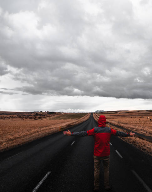 istock man alone on the raod in iceland 674896726
