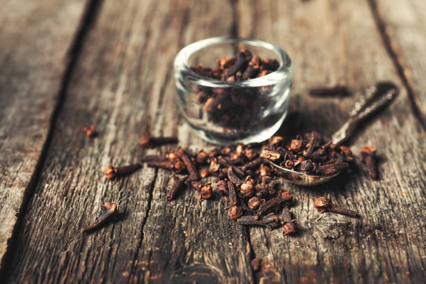 istock Cloves, old wooden background 674899190