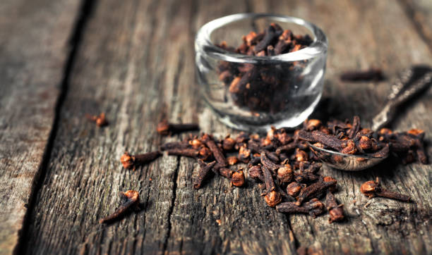 istock Cloves, old wooden background 674899324