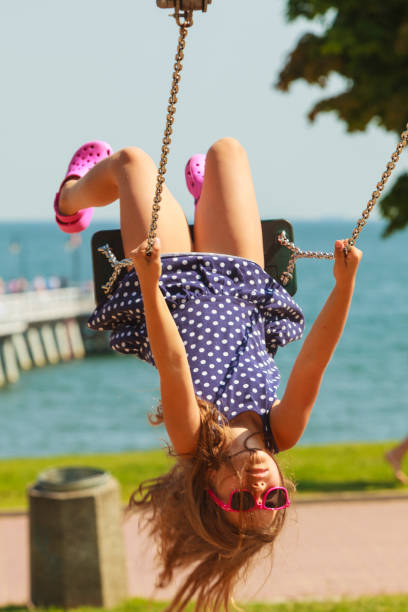 istock Playful crazy girl on swing. 674899396