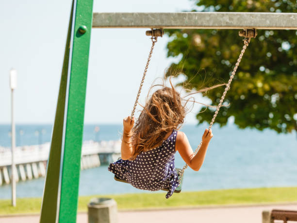 istock Girl swinging on swing-set. 674903586