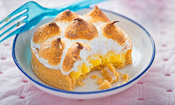 istock Lemon meringue tart with fork eaten 674904048