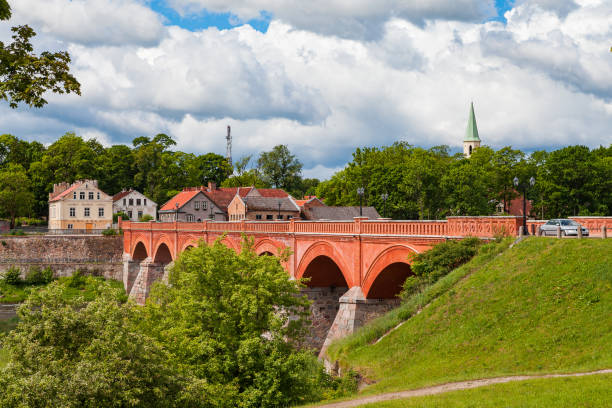 Old brick bridge over Venta river in Kuldiga, Latvia. Summer time. stock photo