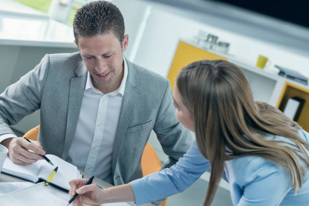 istock Two colleagues having a meeting in an office 674909738