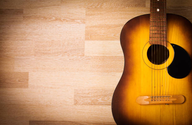 istock Acoustic guitar resting against a blank grunge background 674916284