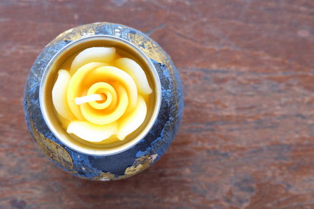 istock Rose Candle on Wood Table. 674916836