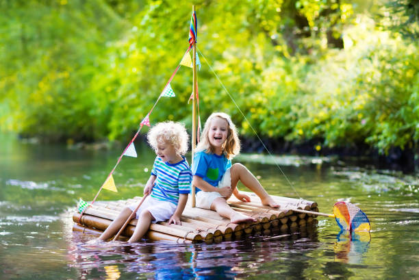 istock Kids on wooden raft 674920414