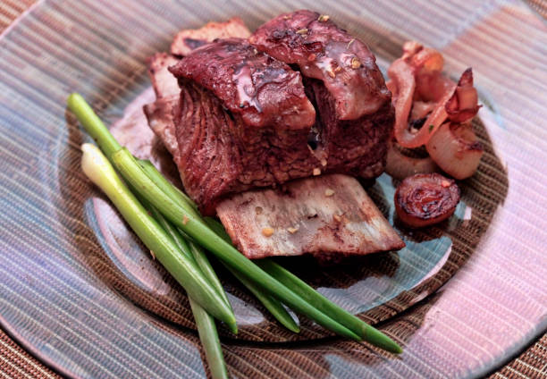 istock Roast red beef meat bbq bloc served on black plate with green chives 674933422