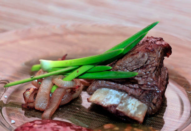 istock Roast red beef meat bbq bloc served on black plate with green chives 674933428