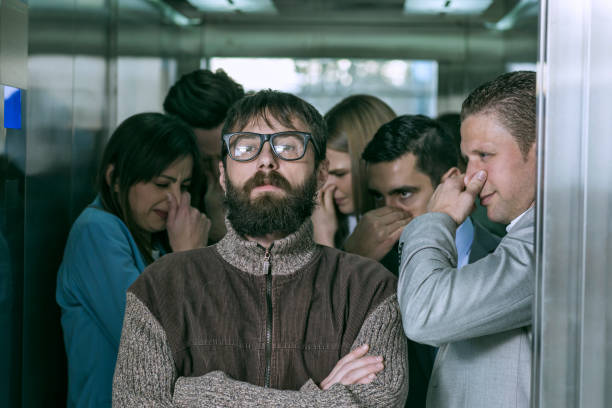 istock A dirty hipster affecting his coworkers in an elevator 674933776