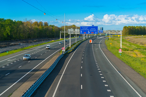 Almere, The Netherlands, April 26, 2016: Cars driving by on the highway A6 between Amsterdam and Lelystad at the Almere Junction