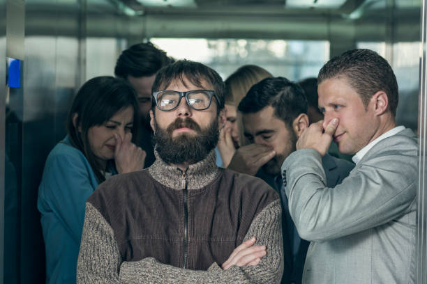 istock A dirty hipster affecting his coworkers in an elevator 674934034