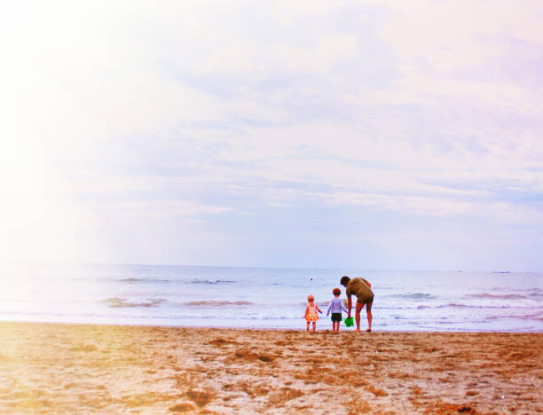 istock Father and His Children at the Beach 674937756
