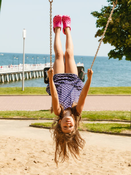 istock Playful crazy girl on swing. 674937798