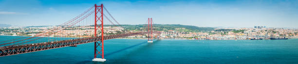 bridge across blue bay to city beyond lisbon panorama portugal - porto portugal bridge international landmark imagens e fotografias de stock