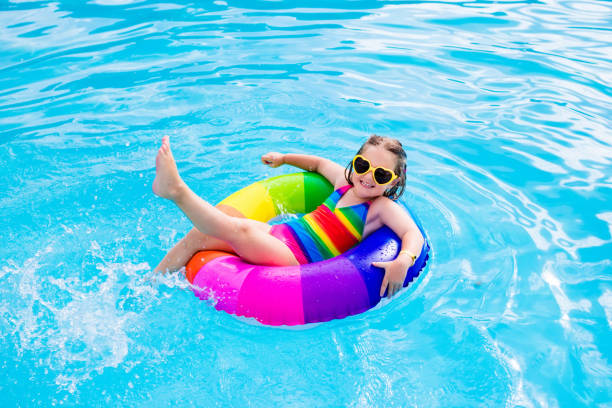 istock Child with toy ring in swimming pool 674941236