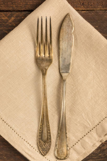 istock Vintage fork and knife on wooden background 674952508