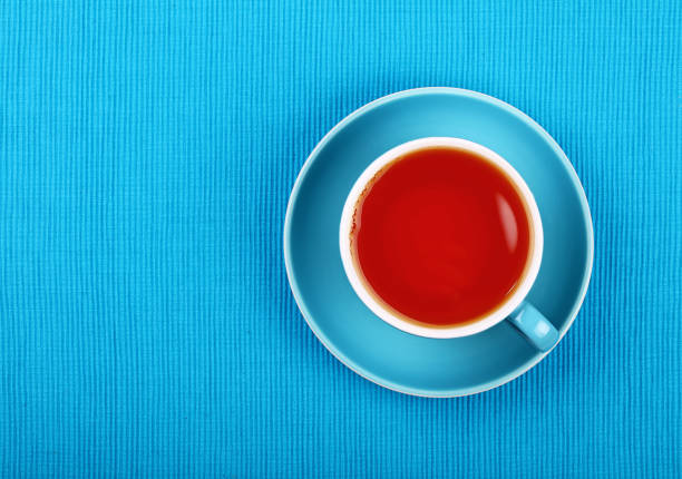 istock Full black tea in blue cup close up top view 674956250