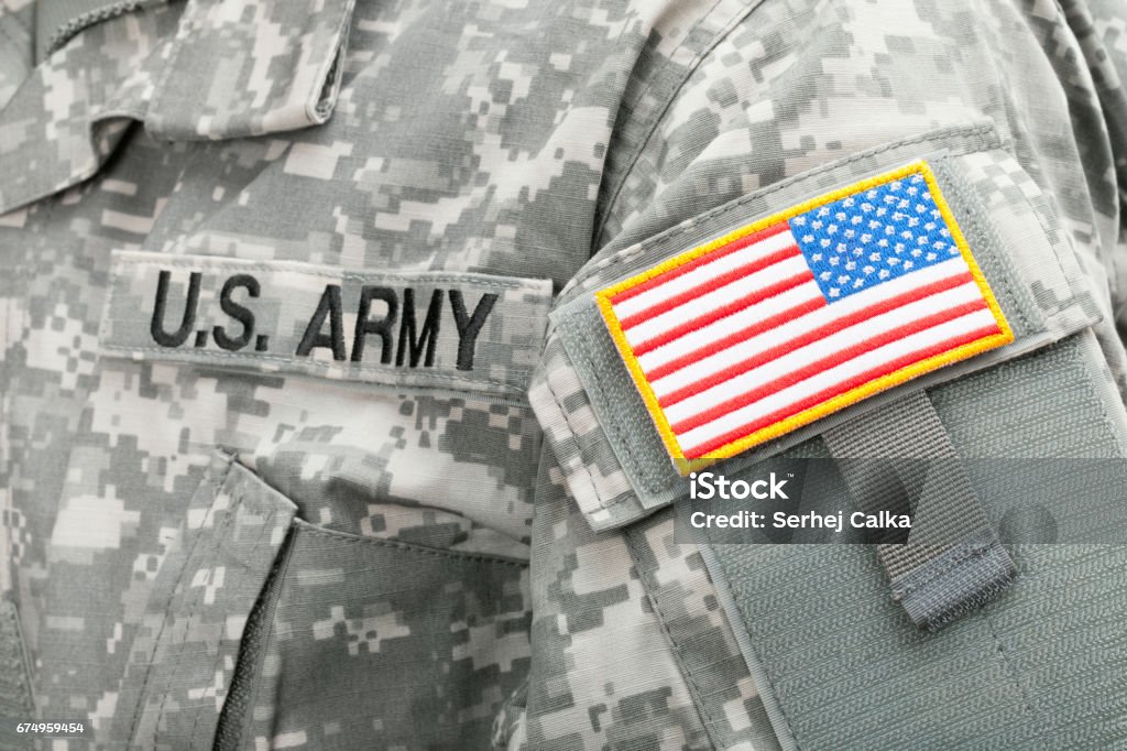 Close up studio shot of USA flag and U.S. ARMY patch on solders uniform Studio shot of USA flag and U.S. ARMY patch on American solders uniform Army Stock Photo