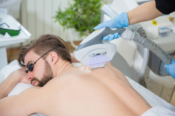 istock Beautician giving men laser epilation 674966738