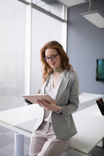 istock Beautiful businesswoman using tablet in information technology and banking 674967376