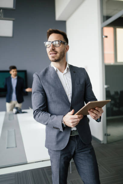 istock Handsome businessman using tablet pc in business office 674967440