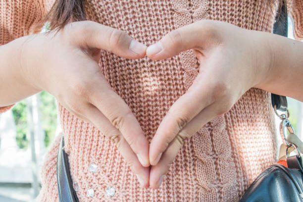 istock focus woman hands make heart symbol 674969902
