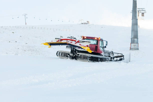 istock Red ratrack preparing a slope for riding near cable car pillar 674970182
