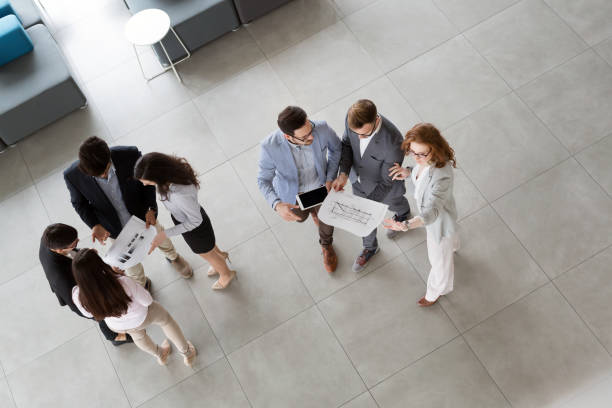 istock Professionals business colleagues collaborating and discussing project plans 674970536