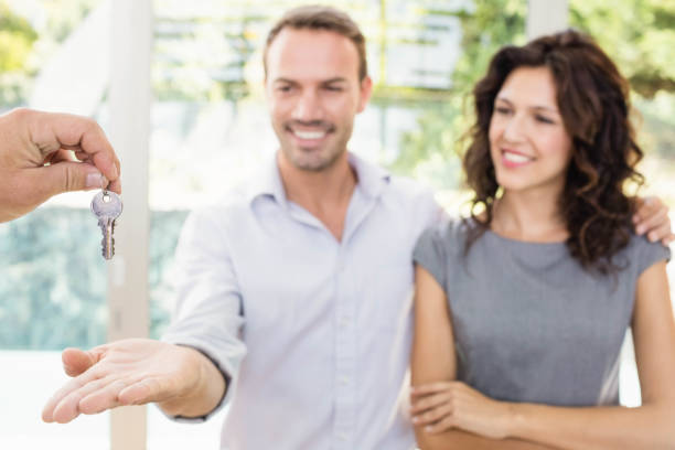 istock Real-estate agent giving keys 674976766