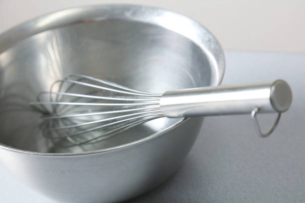 istock stainless Whisk and stainless bowl on white background 674976802