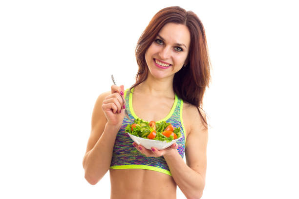 istock Sportive woman holding salad 674980366