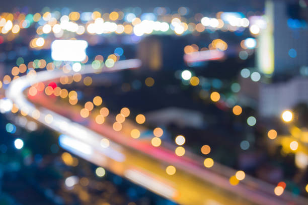 istock Aerial view night city road curved blurred bokeh light 674980980