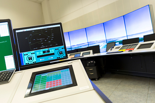 Air traffic surveillance control room interior. Computer monitors.